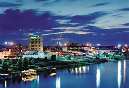 Night view of Alexandria, LA skyline with reflections in river